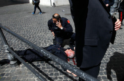 A Carabiniere police officer lies on the ground after gunshots were fired in front of Chigi Palace in Rome April 28, 2013. Two police officers were shot and wounded outside the Italian prime minister&rsquo;s office as Enrico Letta&rsquo;s new government