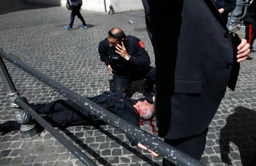 A Carabiniere police officer lies on the ground after gunshots were fired in front of Chigi Palace in Rome April 28, 2013. Two police officers were shot and wounded outside the Italian prime minister’s office as Enrico Letta’s new government