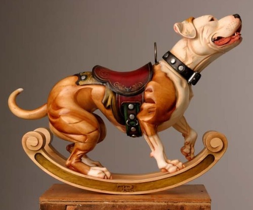 bochelly:  OH MY GOD THIS ARTIST. HE IS AMAZING. DOGS AND CAROUSELS. HE MAKES CUSTOM CARVED DOGS. 