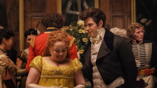 Colin and Penelope gossiping in the middle of a crowded room