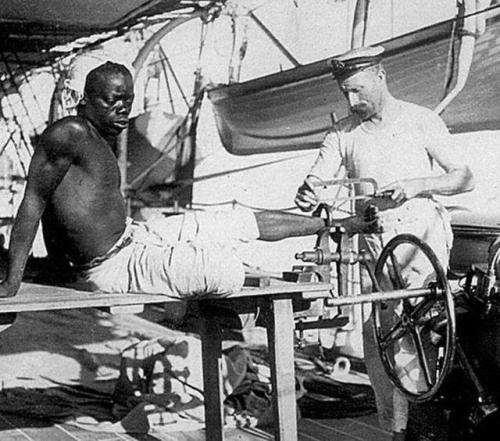 historicaltimes:British merchant on the HMS Sphinx removing a slave’s restraints for the final time.