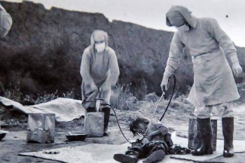 Unit 731 members infecting a Chinese citizen with the bubonic plague as part of an experiment