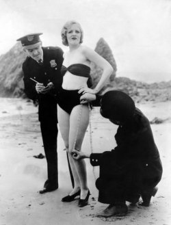 hurricanelaura:  weirdvintage:  Policemen measuring Peggy Graves’s swimming costume, to check whether it meets minimum clothing requirements, 1933 (via Retronaut)  Her face, oh my goodness! I’m right there with you, Peggy! 