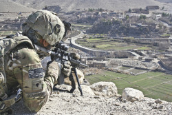 militaryarmament:  An infantryman with Company C, 1st Battalion, 133rd Infantry Regiment, Task Force Ironman, looks down on a spot in Tupac, Afghanistan, Jan. 21, 2011, where his unit had been attacked by an improvised explosive device two days earlier. 