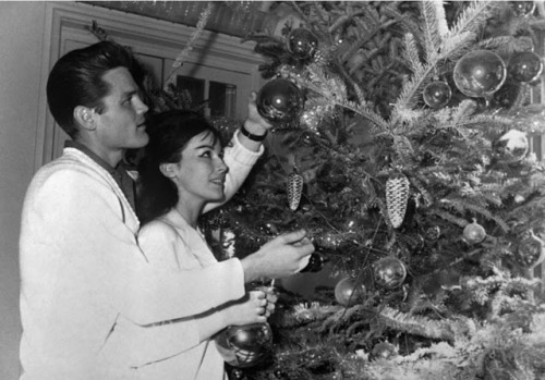 Chet Baker helps his girlfriend, British showgirl Carol Jackson adorn their Christmas tree in Lucca,