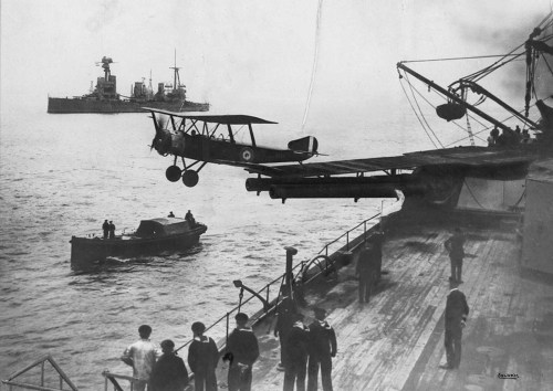 A Sopwith ½ Strutter biplane takes off from a platform built on top of the HMAS Australia&