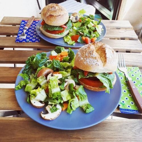 Vegan burgers Cross and soft burger buns topped with avocado, lemon juice tomato quinoa spread, sala