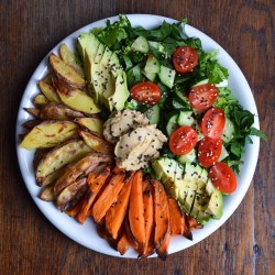 zixxie:  clairesdeli:  Baked oil free potatoes/ sweet potatoes w/ spinach and curly lettuce, tomatoes, cucumber, homemade hummus, ½ avo, tamari sauce and black &amp; white sesame seeds after 2 hours of exercising/ gym 👀👌🏻  This looks so nice