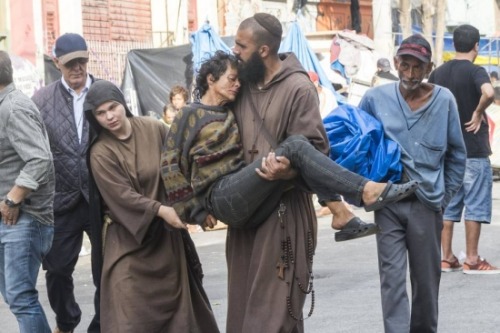 globalchristendom:A monk and nun carry an injured homeless person following a police crackdown on dr