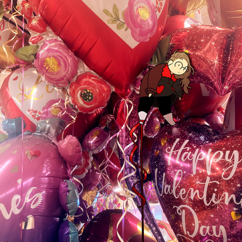 Description: A photo of a collection of Valentine’s Day helium balloons.  Amongst the bal