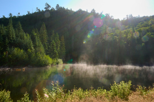 Morning mist rising off of a small lake on the Trans Canada Highway near Wawa, Ontario.