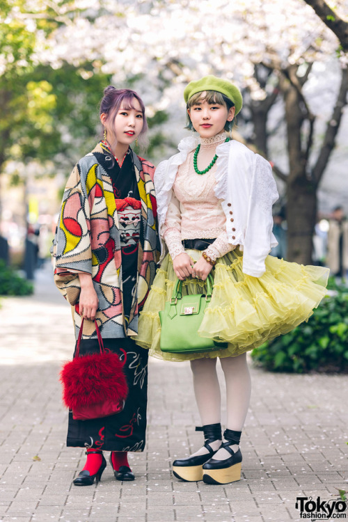 Japanese fashion students Yui and Lina on the street in Tokyo. Yui is wearing a kimono with kitten-h