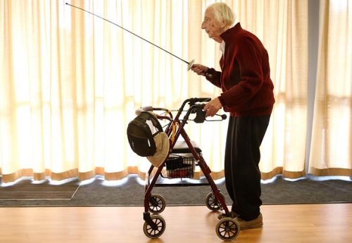 modernfencing:[ID: an elderly man holding a foil, and with a mask hanging from his walker.]A fencer at Corpus Christi Catholic Retirement Home!