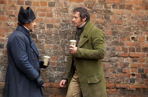 I love all these pictures of the actors wearing period clothes, casually standing around and drinkin