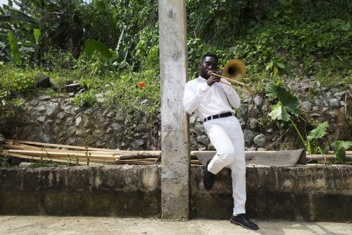Band member rehearses a burial hymn during a funeral service in Tarkwa, Ghana. January 9, 2021. Phot