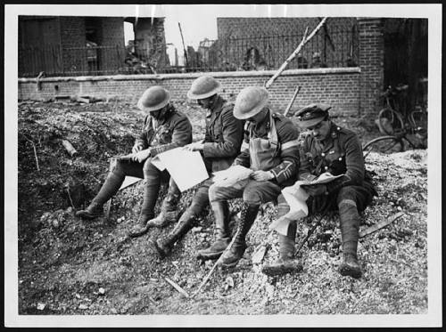 BRITISH OFFICIAL PHOTOGRAPH FROM THE WESTERN FRONT. THE FALL OF PERONNE. British officers studying maps in Peronne.