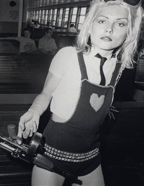 soundsof71: Debbie Harry on the Staten Island Ferry in shades, necktie, and knit studded overalls, w