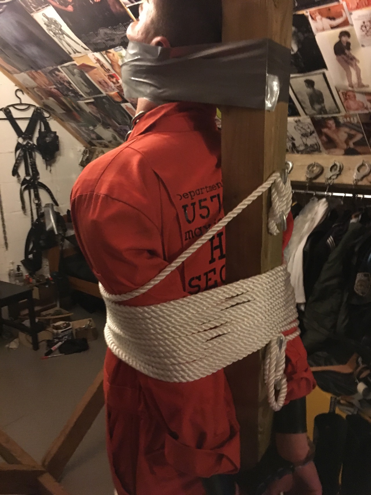 jamesbondagesx: Intruder in uniform and secured in sleep sack, tied to post and milked