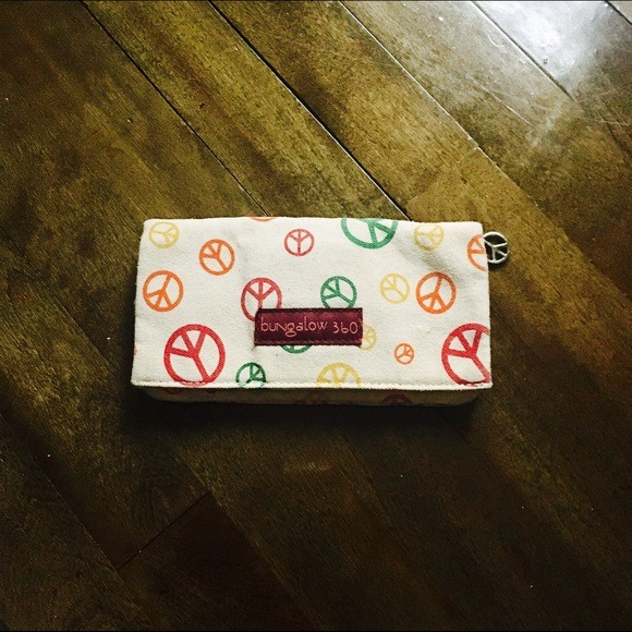 Used only a few times, this wallet is super cute and very roomie! It has a zipper pouch inside and outside for extra storage!