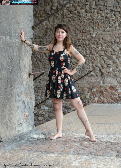 SIZZLING HOT UPDATE from BAREFOOT URBAN GIRLS!!!This week we have TWO  photosets of TWO brand-new barefoot beauties and a 1080X600 HD VIDEO: super-tattooed alt-style beauty FENICE (strutting her powerful, rough-soled & high-arched size