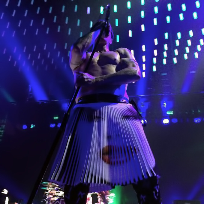Anthony Kiedis wearing a “Makeup Face” pleated skirt by Moschino designer, Jeremy Scott during RHCP’s concert at the PNC Arena in Raleigh, North Carolina on April 15th 2017.