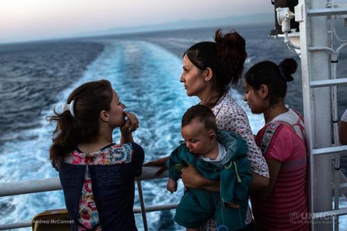 Naleen holds her two-month-old son, Pulat, during the ferry journey from Lesvos to Athens. UNHCR/And