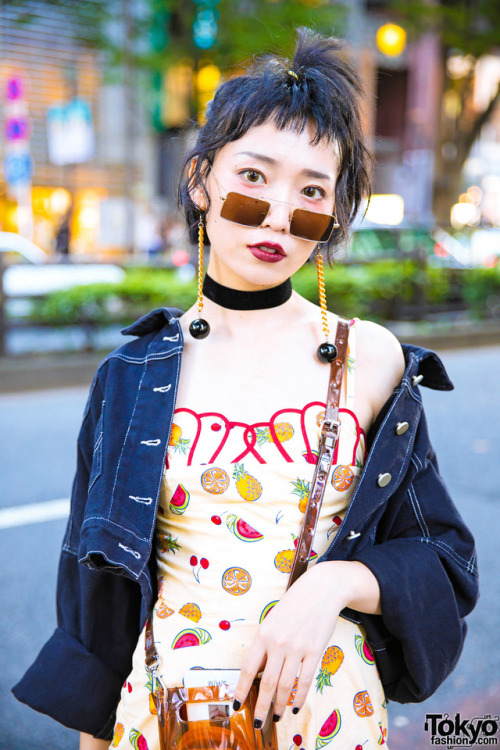 Hao on the street in Harajuku wearing a fruit print romper under a cropped denim jacket, platform sh