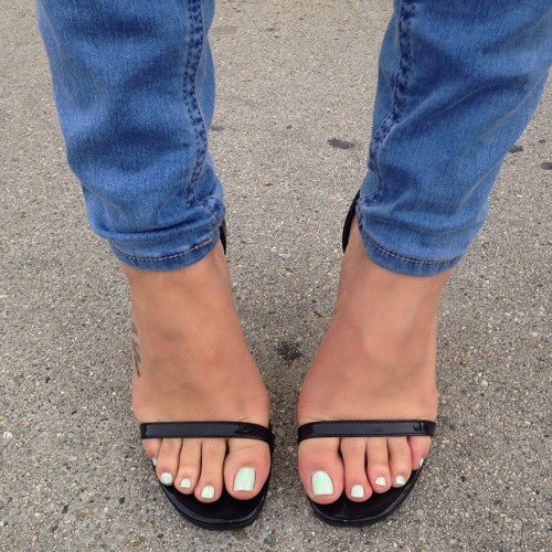 Beautiful feet in heeled sandals.