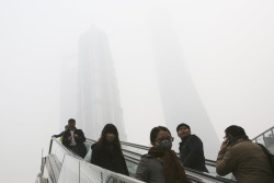 untrustyou:  People traveled on escalators near skyscrapers as a heavy haze blanketed Shanghai. Authorities advised that children stay indoors, among other recommendations, during the bout of air pollution.  (Eugene Hoshiko/Associated Press) 