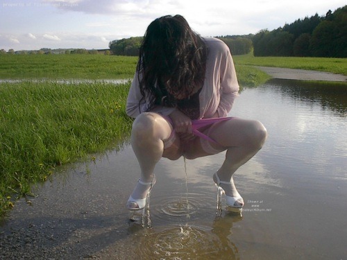 warmthandwetness:   The heels give this a surreal feel. The ripples in the water, the reflection and the shadows make it perfect. 