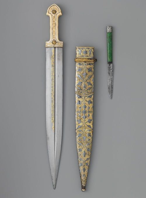 art-of-swords:  Qama Dagger with Sheath and Knife Dated: dated, 1856–57, 1861 Culture: Caucasian Medium: steel, bone, silver, gold, shark skin, ivory, niello, iron Measurements: Dagger (a); L. with sheath 19 ¼ in. (48.9 cm); L. without sheath 19 1/16