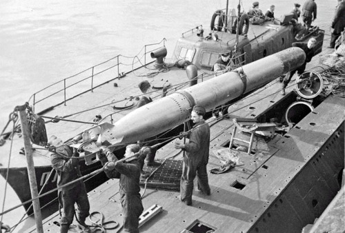 Submarines loading torpedoes