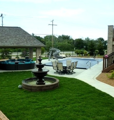 Poolhouse - PoolhouseInspiration For A Mid-sized Backyard Concrete And Custom-shaped Pool House Remodel