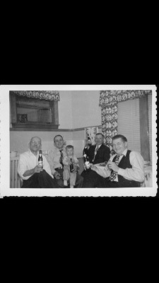 I Started Drinking Young  Me on my dad’s lap. Left to right is Uncle Phil (one of dad’s siblings), dad and me, uncle John (maternal grandmothers brother), and uncle Arnold (hubby to one of my dad’s sisters).  Looks like a holiday at my uncle Phil’s