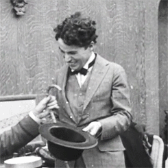 chaplinfortheages:  1919 - Charlie Chaplin shows the Bishop of Birmingham how he