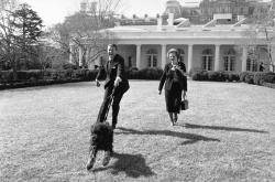 President Ronald Reagan is pulled along by his pet dog &ldquo;Lucky&rdquo; while he and British Prime Minister Margaret Thatcher take a stroll in the White House Rose Garden on Wednesday, Feb. 20, 1985 in Washington. (AP Photo/Barry Thumma) 