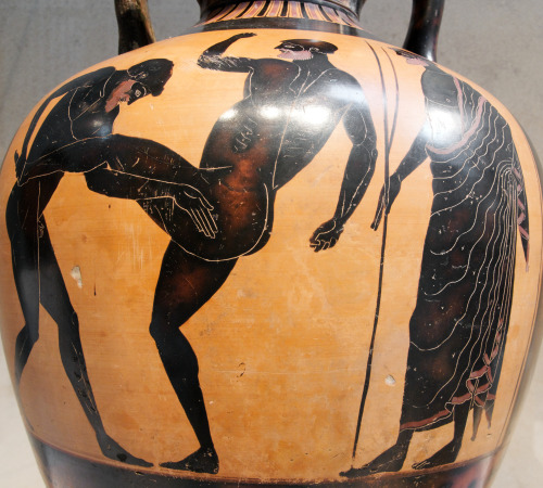 Two competitors in the pankration battle while a judge watches.  Side B of a black-figure Panat