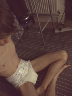 baby-zachy:  Late at night can’t sleep messy boy hair :$, but soaked warm comfy diaper though!, no dummy :(. Kinda gave up hiding my face, I like to think I look cute in a diaper :$ 