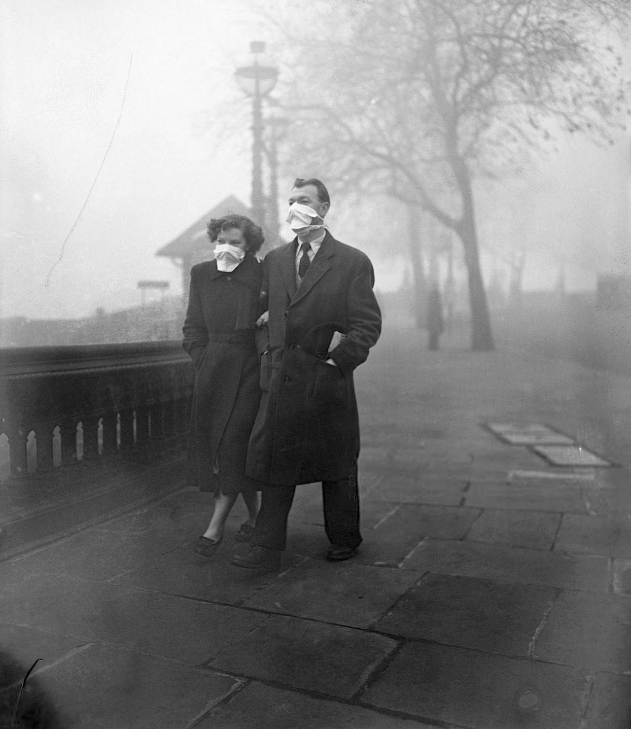 Monty Fresco. A couple wearing masks to protect them from the smog in Blackfriars, London, November 18th, 1954.