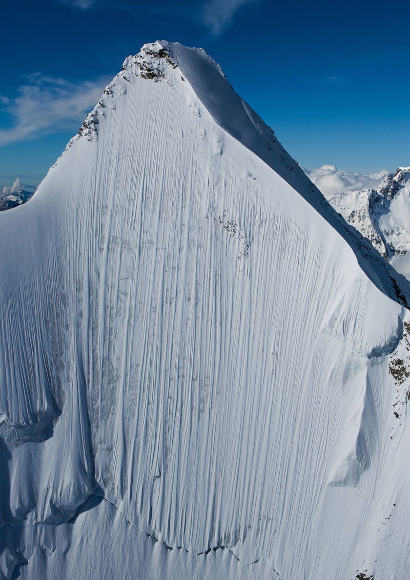 coolthingoftheday: “In this jaw-dropping photo, skiier Jérémie Heitz braves an impossibly steep cliff face in the Pennine Alps of Switzerland. Click here for the enlarged version, so you can spot him better. (Source) ”