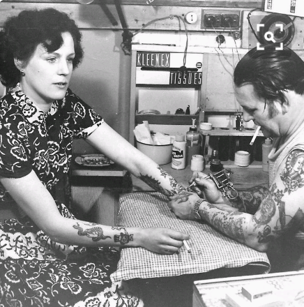 nordengun - vintage photograph of a woman getting a tattoo