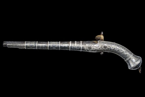 A finely engraved gold and silver decorated Cossack&rsquo;s pistol, early 19th century.Estimated Val