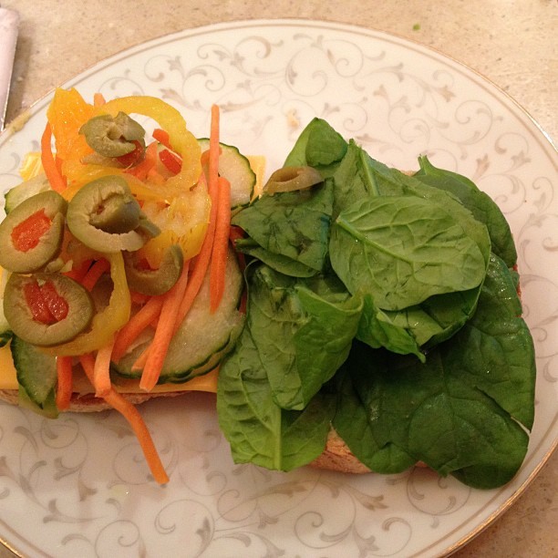 Hummus veggie sandwich for dinner! #yum #hummus #greenolives #spinach #bananapepper