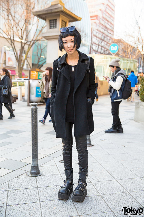 20-year-old Kana on the street in Harajuku wearing an all black outfit with Demonia boots, a neck ta