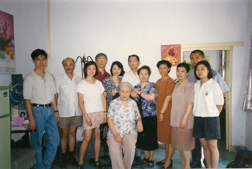 Family portrait in the old Beijing home, around the family matriarch.