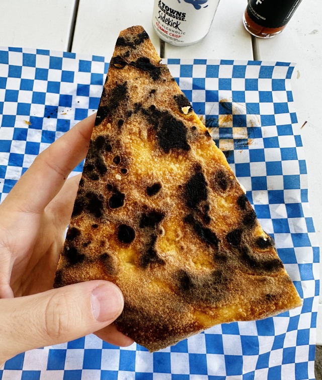 Underside of a well-baked slice of pizza