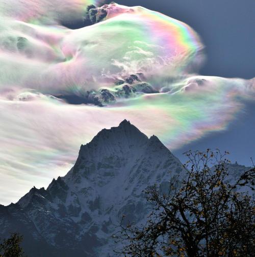 Iridescent Clouds over ThamserkuImage Credit &amp; Copyright: Oleg Bartunov