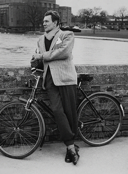 Michael Redgrave resting with his bicycle on the banks of the Avon River in Stratford Upon Avon, Eng