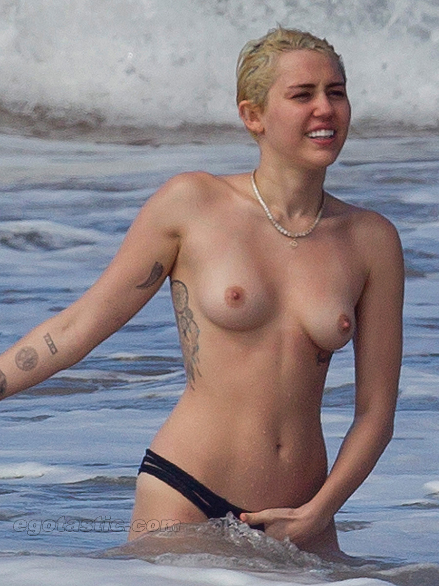 boobs4victory:   Miley Cyrus at the beach in Hawaii  with Patrick Schwarzenegger.