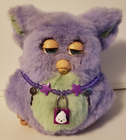 I got a mini Furby necklace from ! I couldn't find much info about them  online, but they came with tootsie roll tubes in the 90's : r/furby